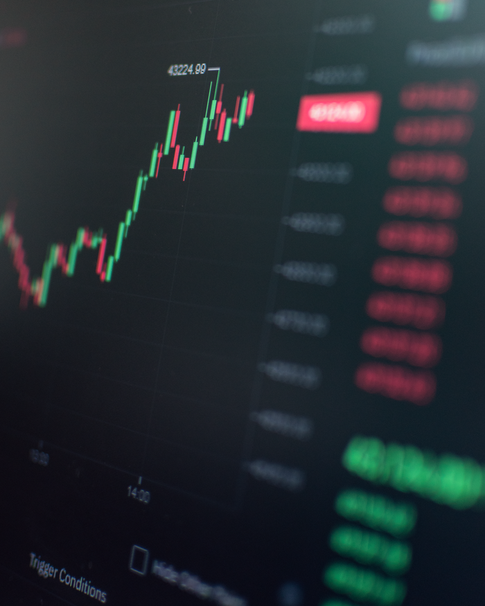 services-01 Close-up of a fluctuating cryptocurrency market chart showing stock prices on a digital screen.